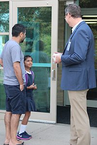 Head of School talking to student