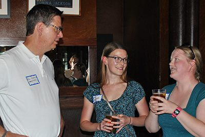 Head of School with two alumni