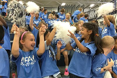 Lower School girls cheering at the Homecoming Pep Rally