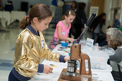 Student making a button