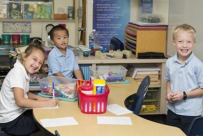 Students working together at table. 