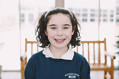 Middle School student in front of bench