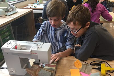 students sewing together crocodile costume