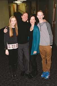 Family of four in school hallway