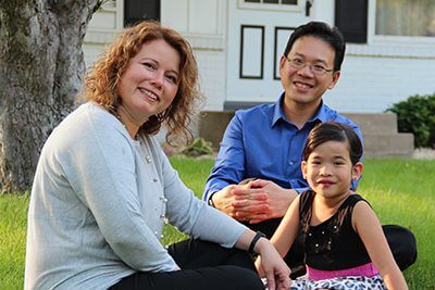 Family of three on lawn