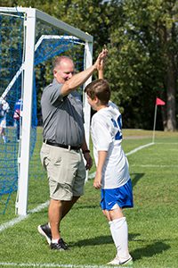 Dan Haase high five with soccer player