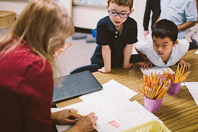 Kindergartners working with teacher