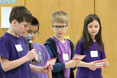 lower school students speaking at assembly