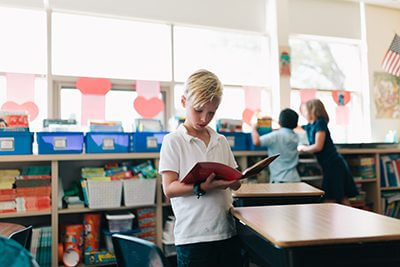 Lower school student reading a book