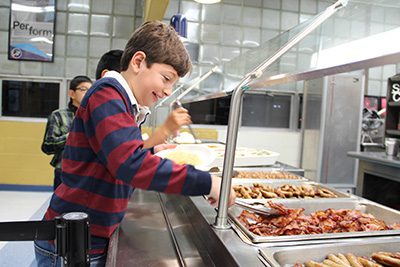 Logan Segal serving himself lunch