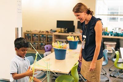 Teacher in Makerspace with young student