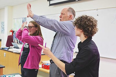 Biology teacher with two students