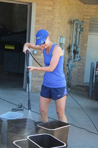 Ms. Meras washing trash bins