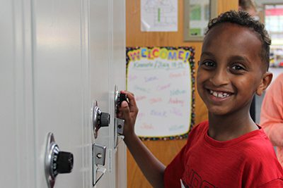 lower school student finds his locker at back to school night