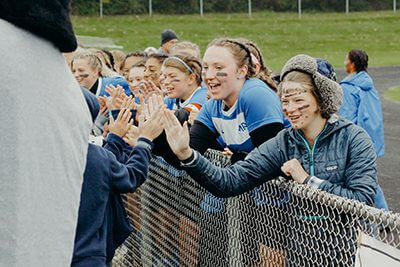 fans line up for high fives at homecoming