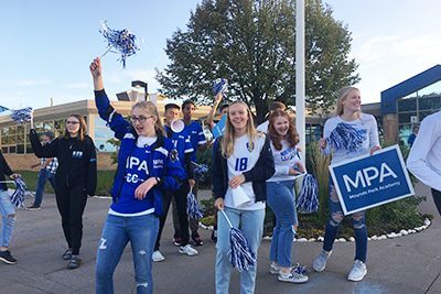 upper school students cheering during homecoming week spirit days