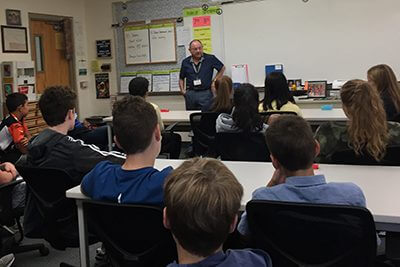 Carlos Espinosa speaking to the middle school students