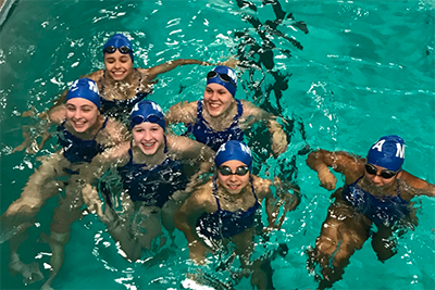 MPA swim team smiling in the pool