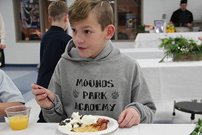 students enjoying the pancakes at the breakfast