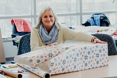 parent volunteers wrapping gifts for faculty and staff