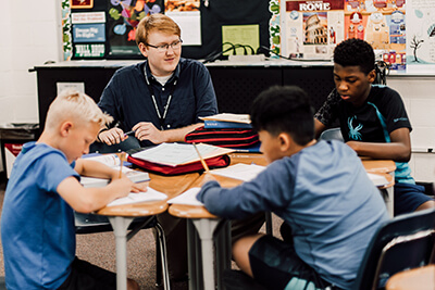 middle schools students and teacher working together 