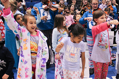 lower school students dancing at the pajamarama concert