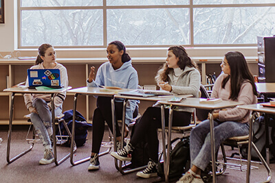 upper school students leading a discussion in class