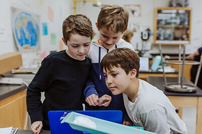 middle school students observing science experiment