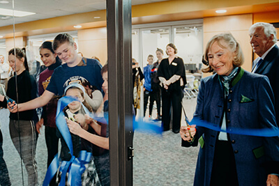 Ingrid cutting the ribbon to the library