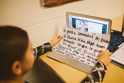 middle school student doing Spanish on computer