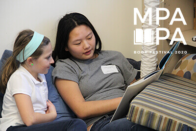 upper school student reading at a pairing assembly