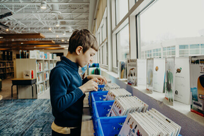 student looking through library books