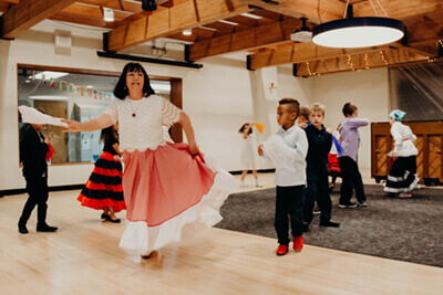 Martha dancing with students on culture day