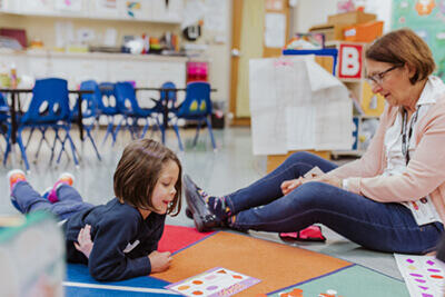 Patricia playing with a PreK student