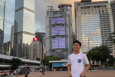 Justin Choi in front of skyscrapers