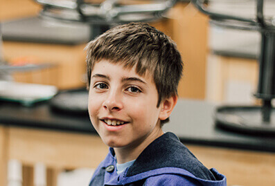 middle school student smiling at the camera