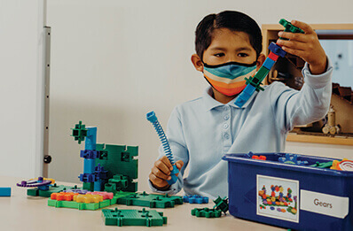 lower school student building in the makerspace