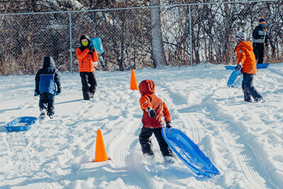 lower school students playing in the snow