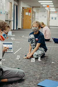 middle school students doing a lab in the hallway