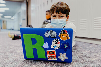 Student in the hallway on laptop