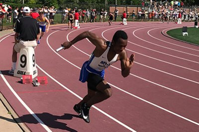 Upper school student racing in track meet