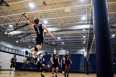 Luke Zscheile smashes a spike in the Lansing Sports Center