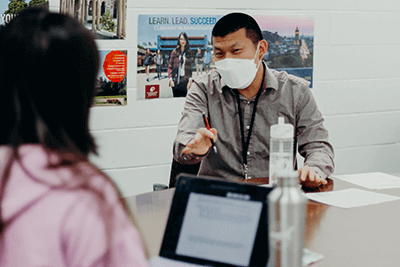 Cory working with an international student