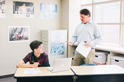 Mr. Vergin talks with a student