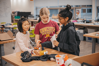 middle school students working in the makerspace