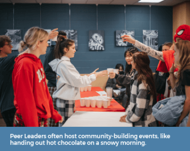 Peer Leaders often host community-building events, like handing out hot chocolate on a snowy morning.