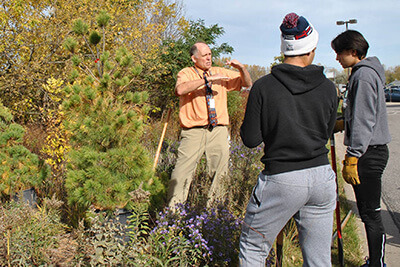 Mr. Thomsen working in the gardens with students