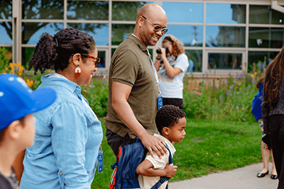 A Lower School Parent walking his student inside. 