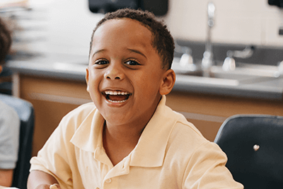 Lower School student smiling at the camera 