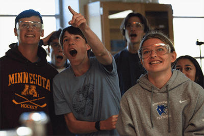 Upper School students excited in a chemistry lab